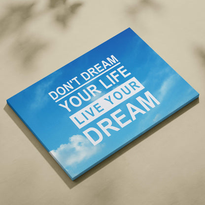 Blue canvas print with bold white live your dream motivational typography against a sky background for home decor