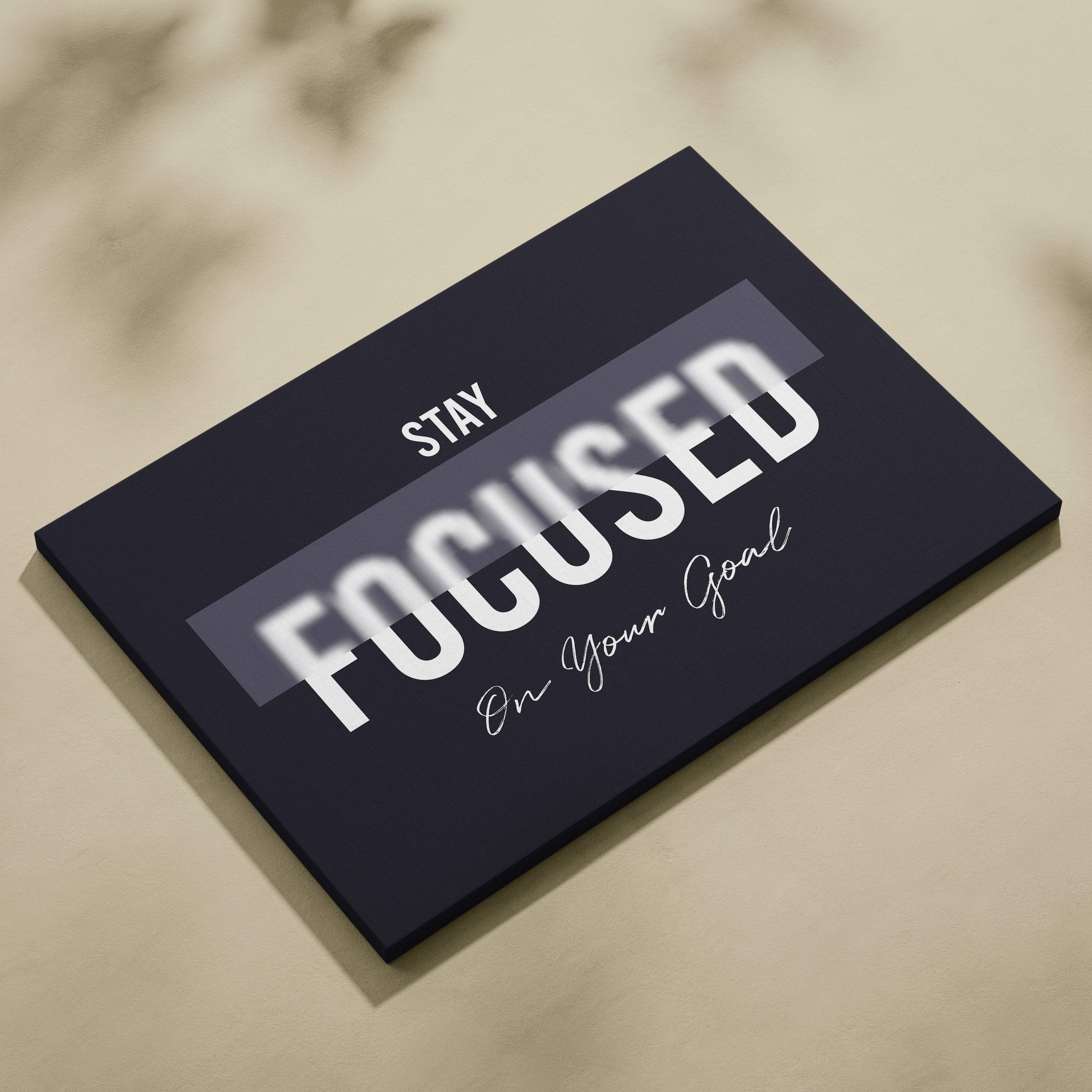 Black canvas print with bold white and cursive stay focused on your goal motivational phrase for office gym decor