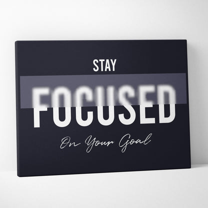 Black canvas print with stay focused on your goal motivational phrase in white typography for office bedroom or gym decor