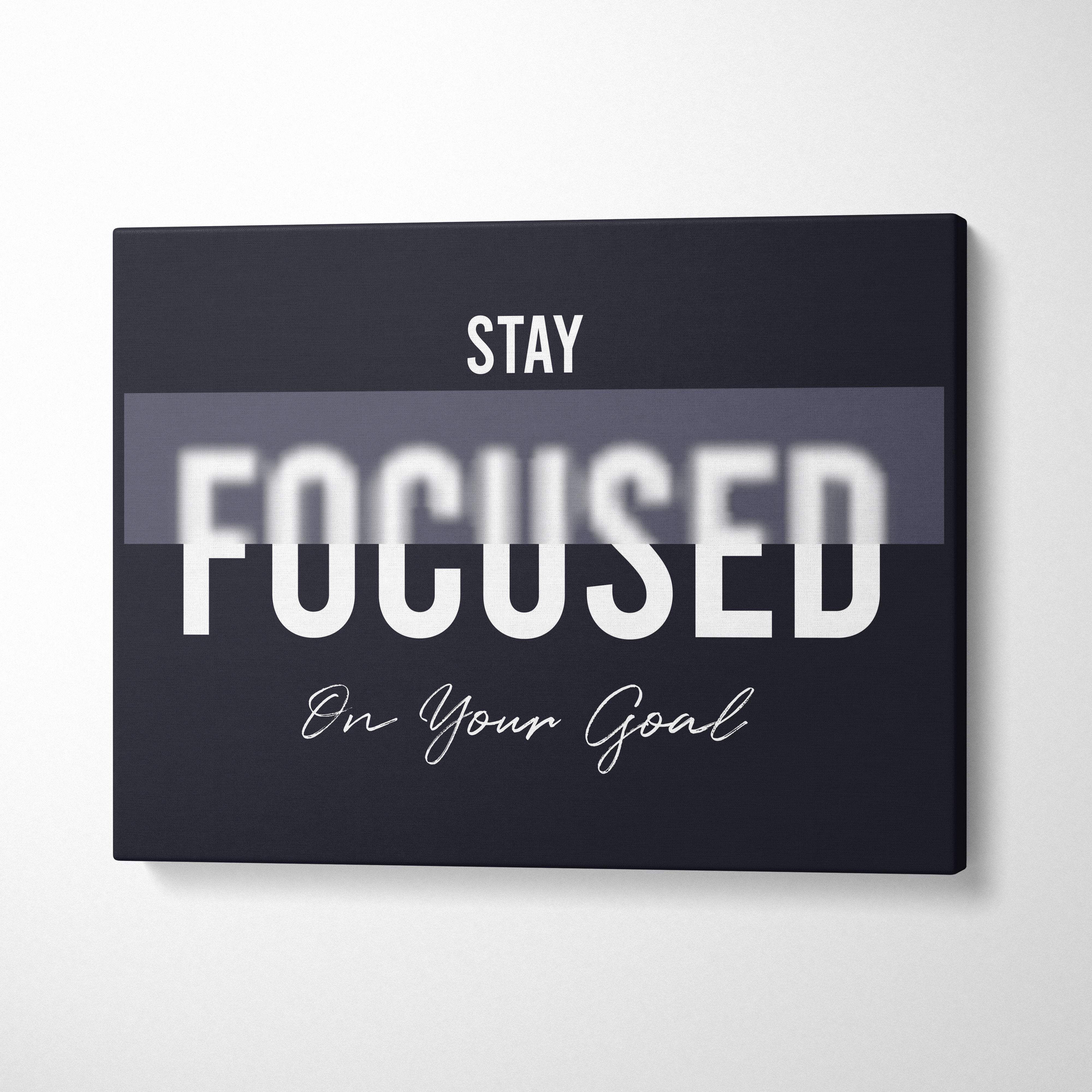 Black canvas print wall art with stay focused on your goal motivational phrase in white typography for office bedroom gym decor