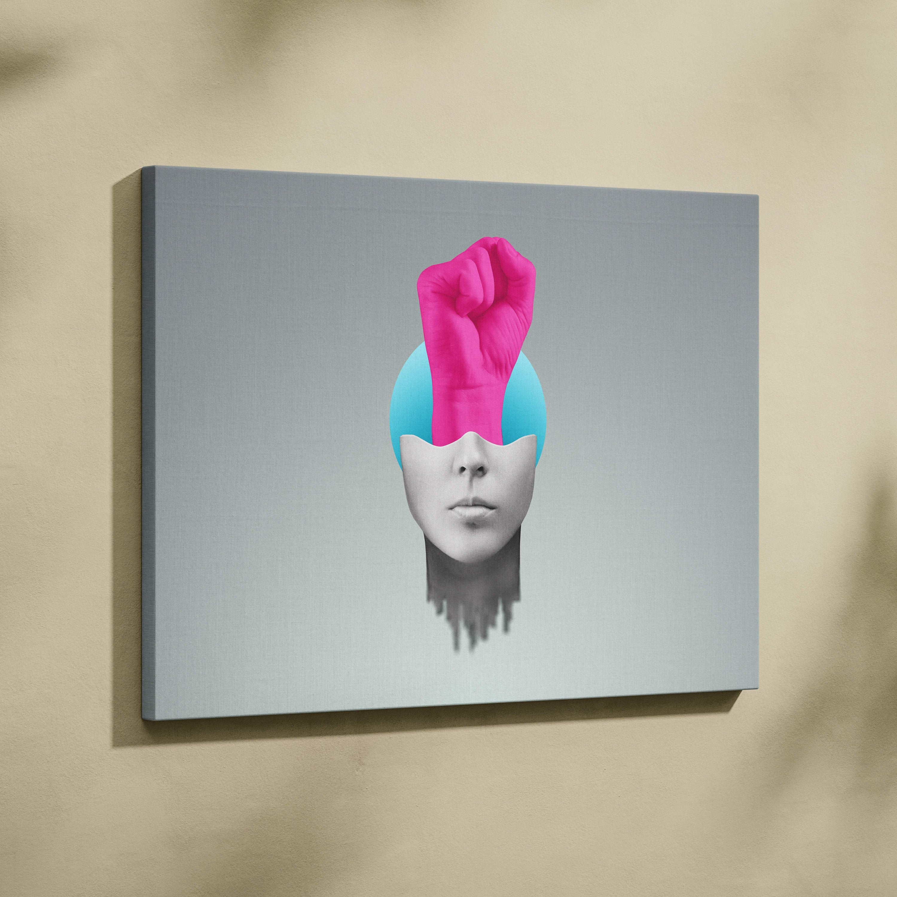 Contemporary pink fist canvas wall art featuring a vibrant pink fist from a blue sphere on a gray human face