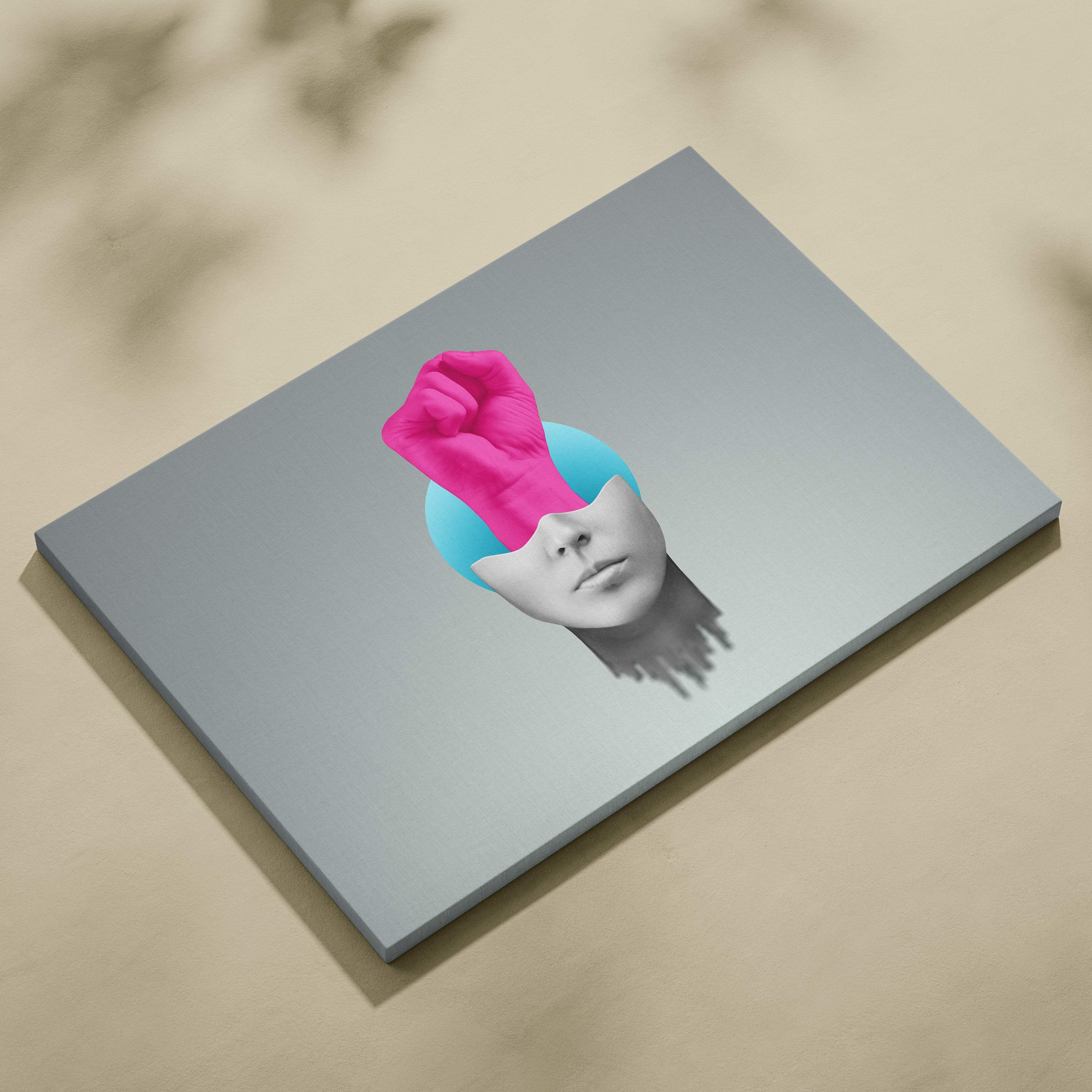 Contemporary pink fist canvas wall art with stylized face and vibrant pink fist on light blue background for empowerment decor