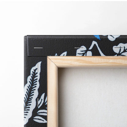 Light wood frame with black canvas of blue white botanical leaves art