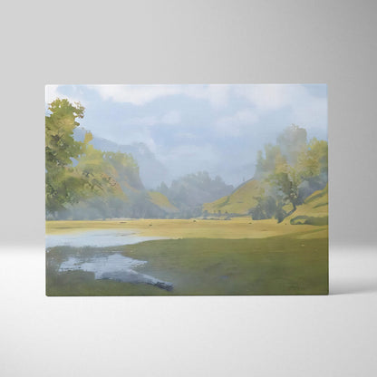 Soft misty meadow landscape canvas print featuring a misty green forest, rolling hills, and a reflective waterway under blue sky