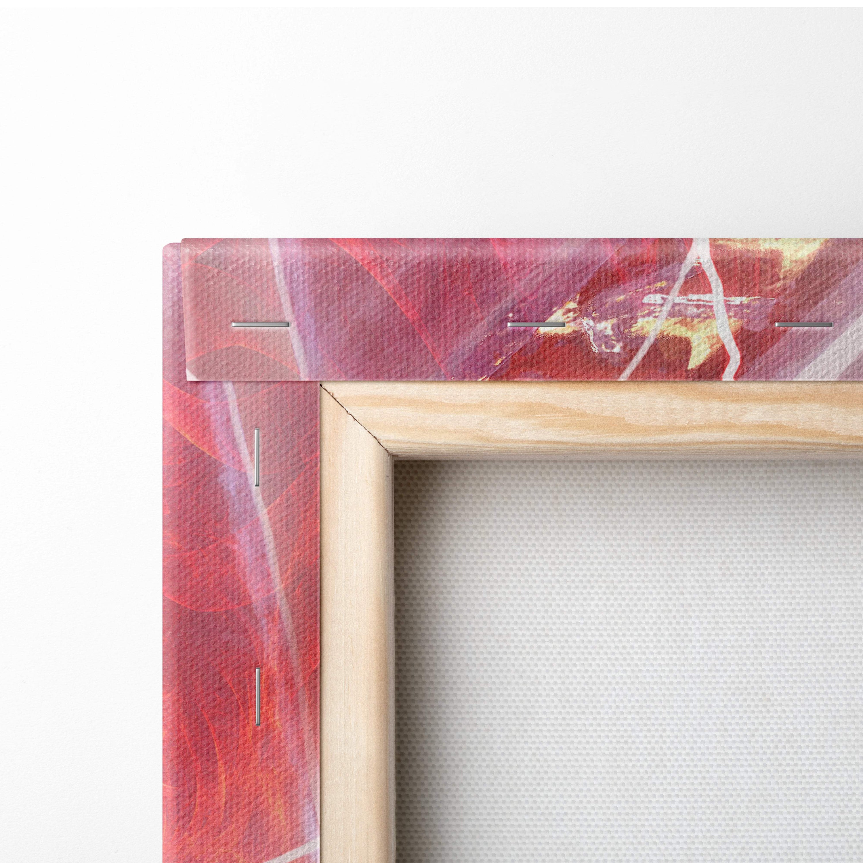 A vibrant abstract canvas painting with red and pink brushstrokes in a natural wood frame for wall decor