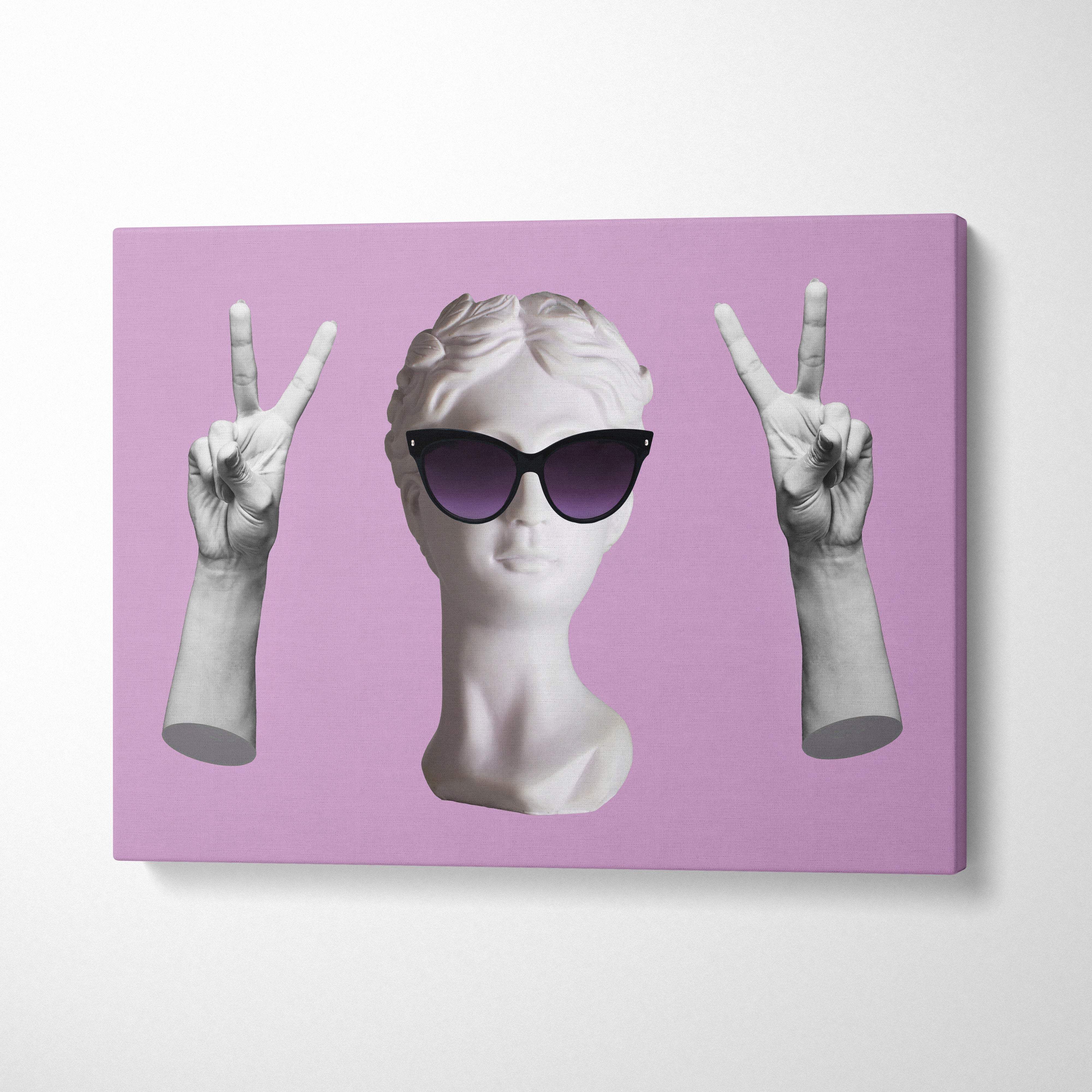 A matte lavender canvas print with a white marble bust wearing black cat-eye sunglasses and peace sign hands
