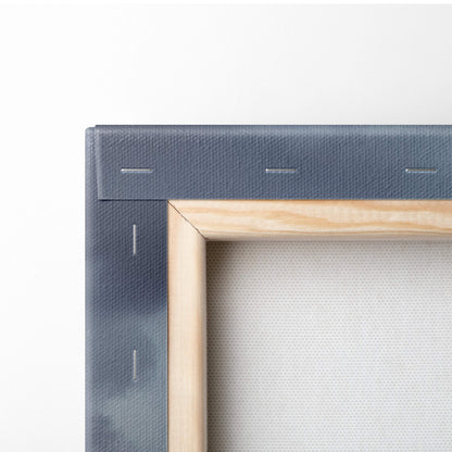 Minimalist canvas painting with light wood frame and dark gray textured border featuring dark blue thunderclouds