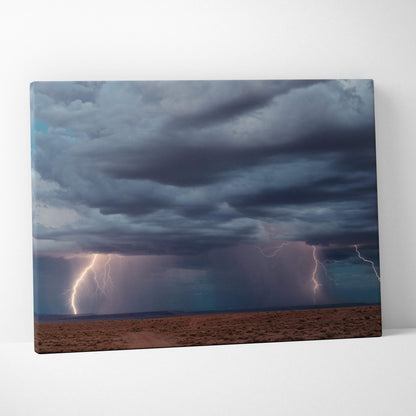 Stormy sky canvas print with dark blue thunderclouds and vivid lightning bolts over a desert landscape wall decor