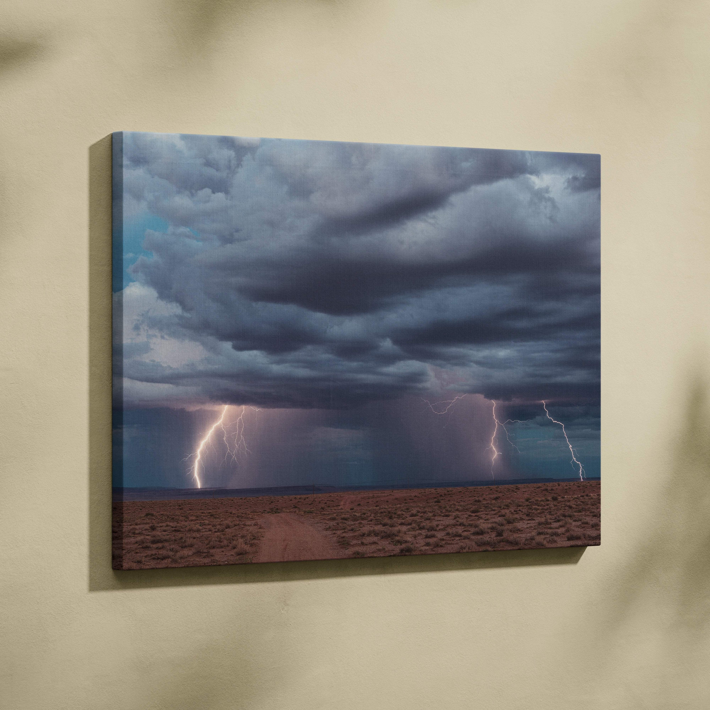 Canvas print of multiple vivid lightning bolts striking a desert under dark blue thunderclouds dramatic landscape wall decor