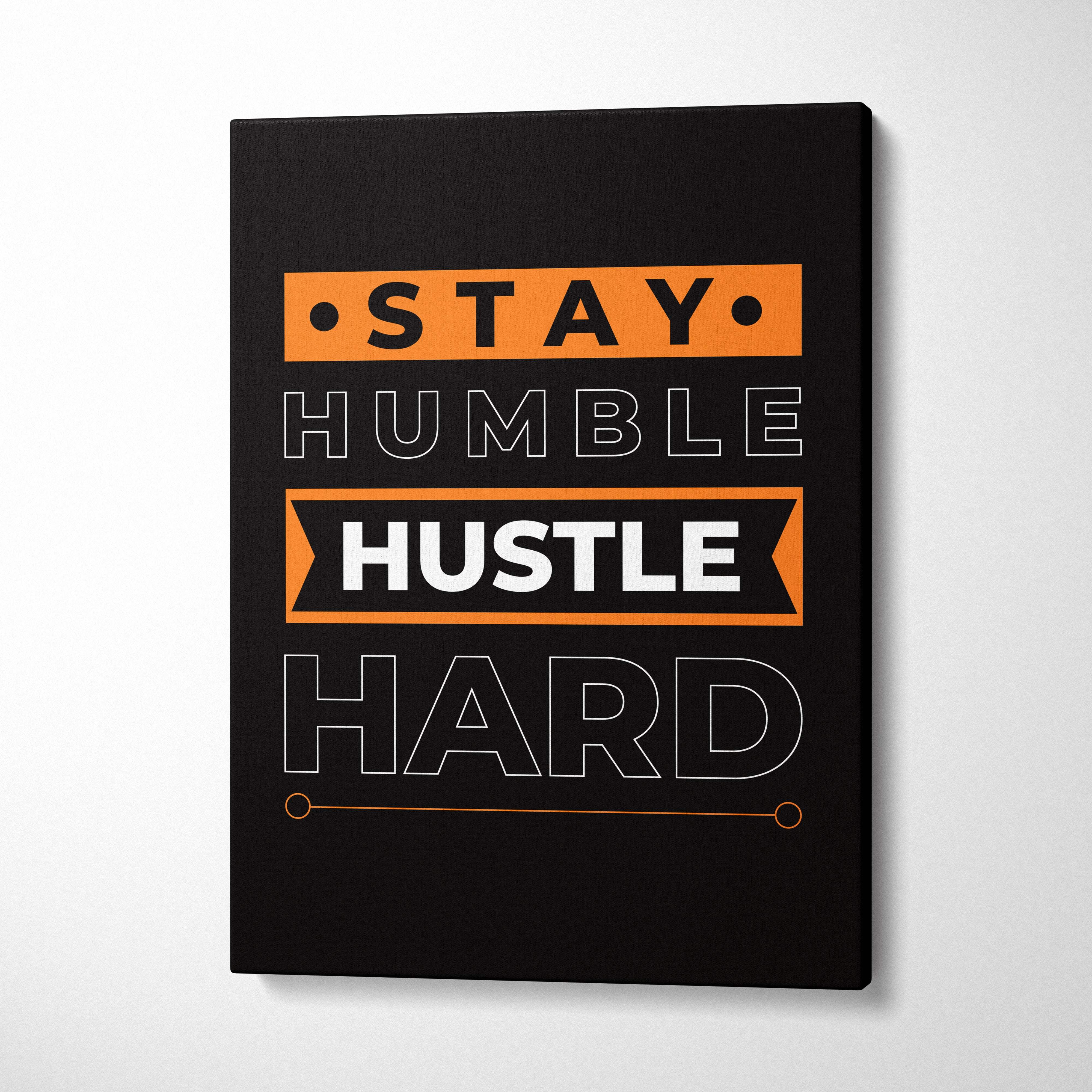 Black canvas print with stay humble hustle hard in bold white and orange typography motivational wall art for office gym or home