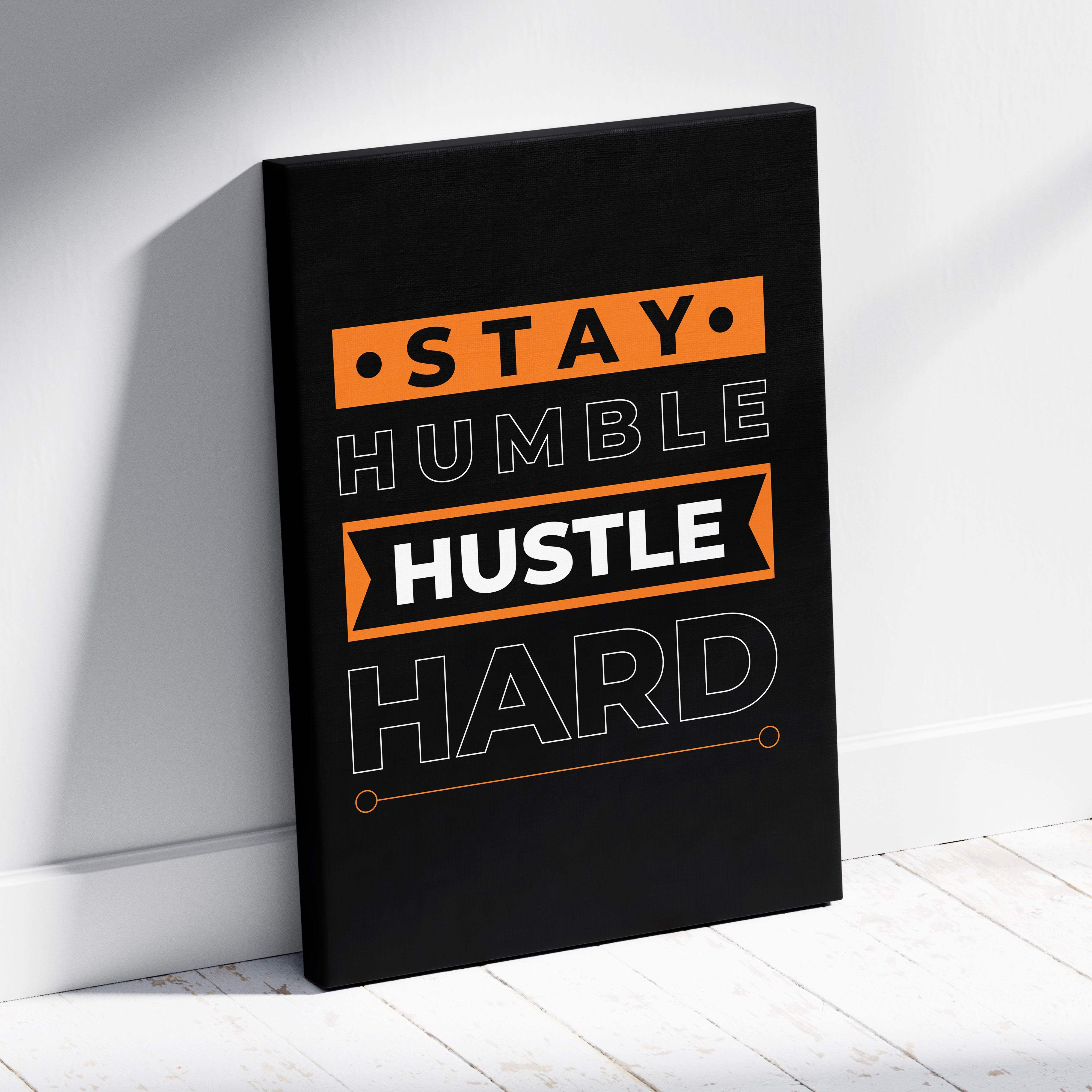 Black canvas print featuring stay humble hustle hard motivational phrase in bold white and orange with geometric accents