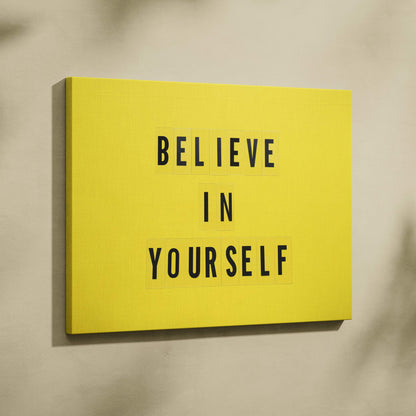 Bright yellow canvas wall art with bold black letter tiles displaying believe in yourself for office or home decor