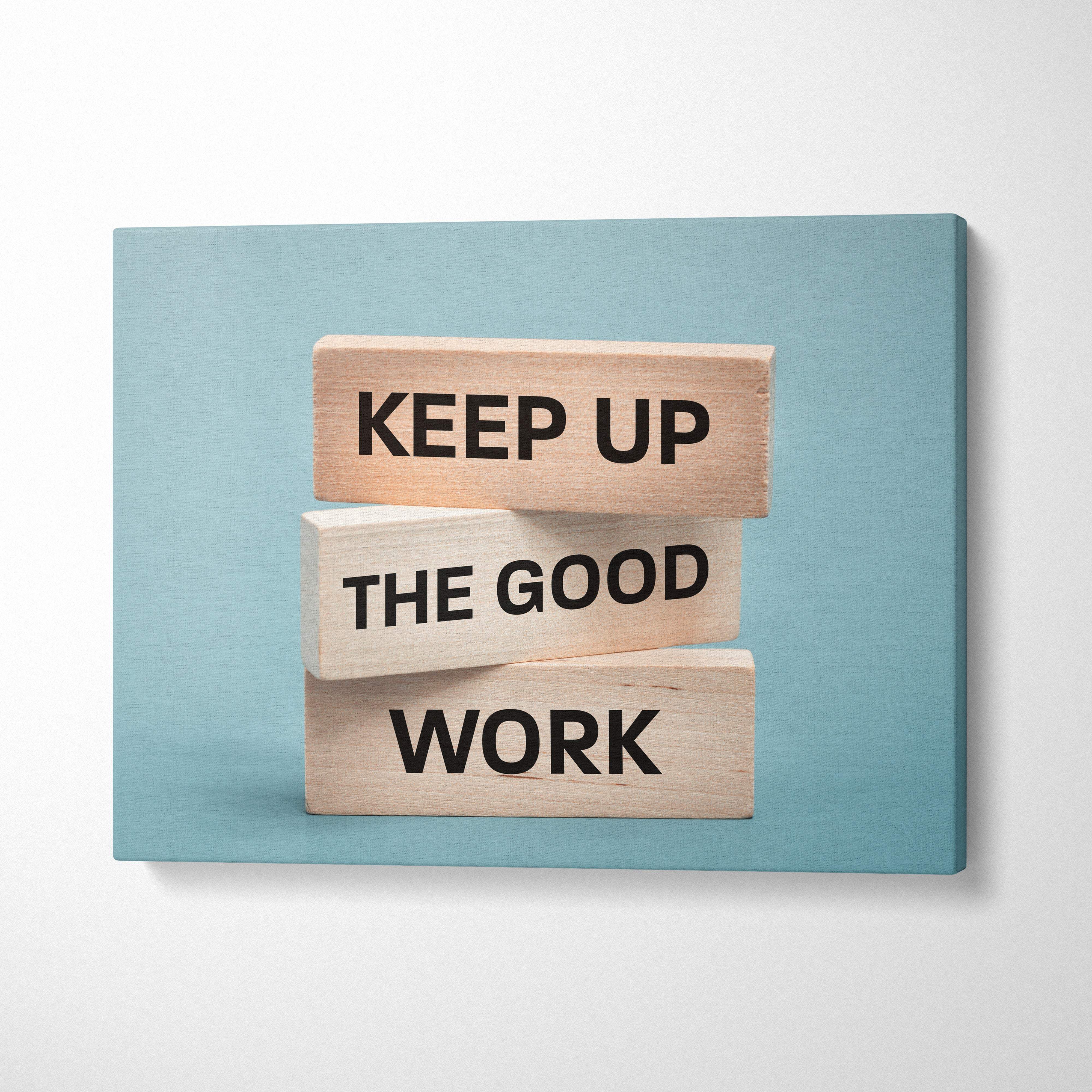Light blue canvas wall art with stacked wooden blocks and black text reading keep up the good work motivational print