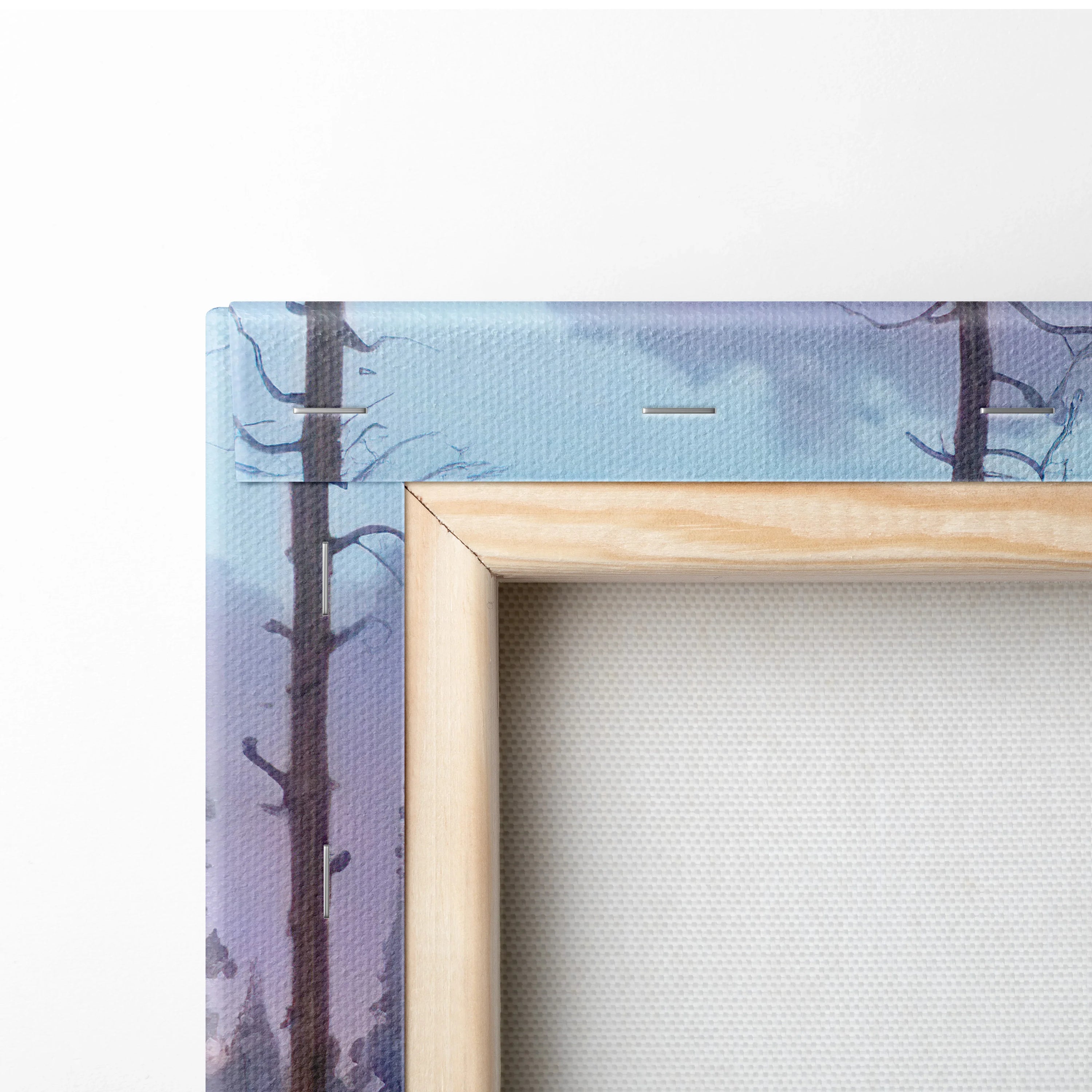 Close-up of natural wood frame corner on watercolor forest sunset canvas wall art with visible canvas texture.
