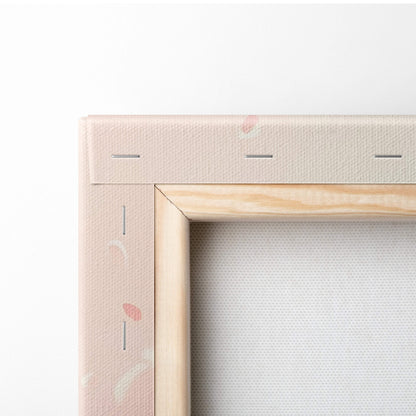 Beige canvas painting with light wood frame featuring pink cherry blossom branch in soft blush floral petals design