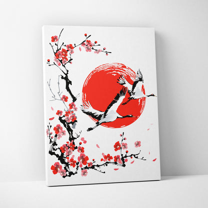 White canvas wall art with bold red sun black branches pink blossoms and two white cranes in japanese ink style