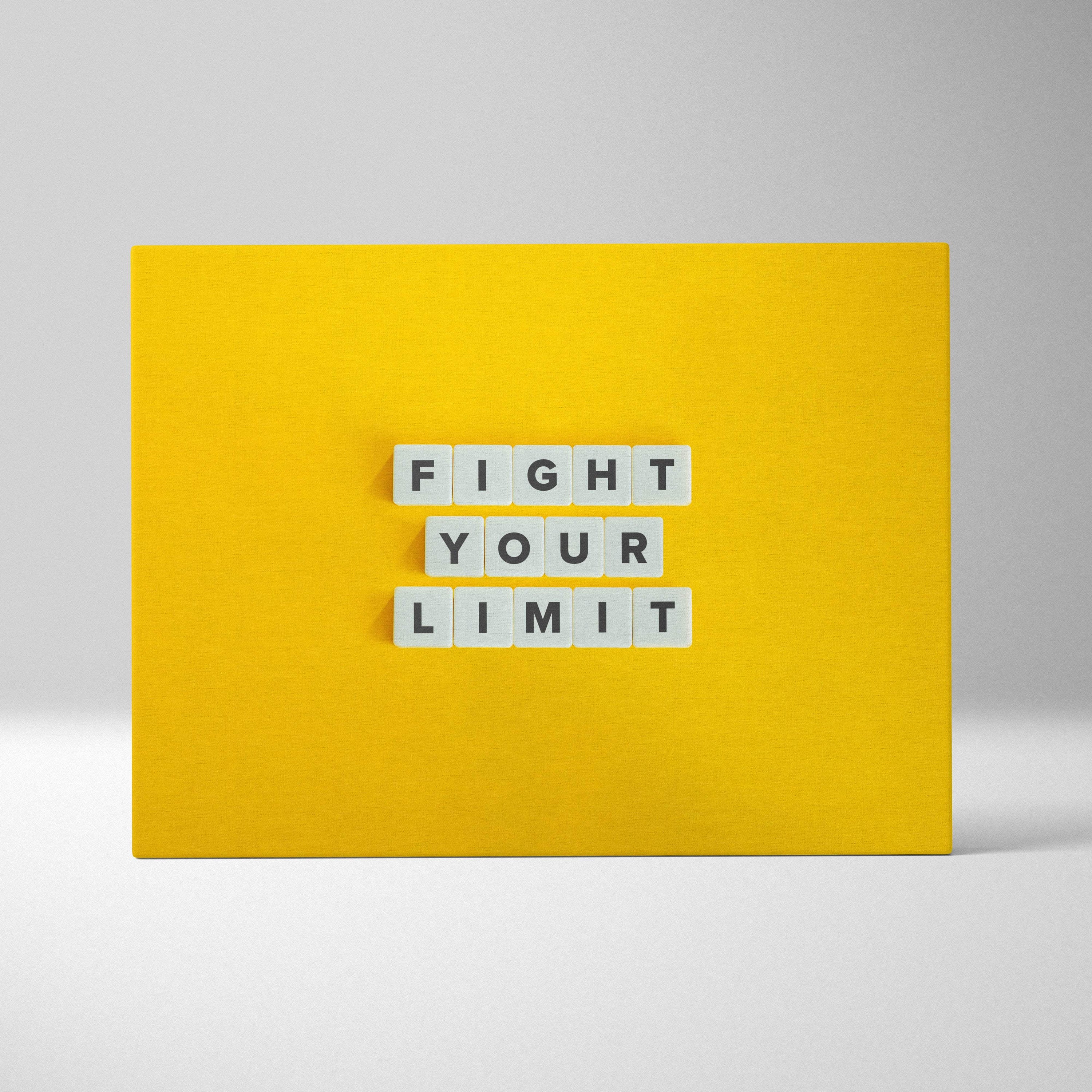 Bright yellow motivational wall art print with white letter tiles spelling fight your limit for gym or home decor