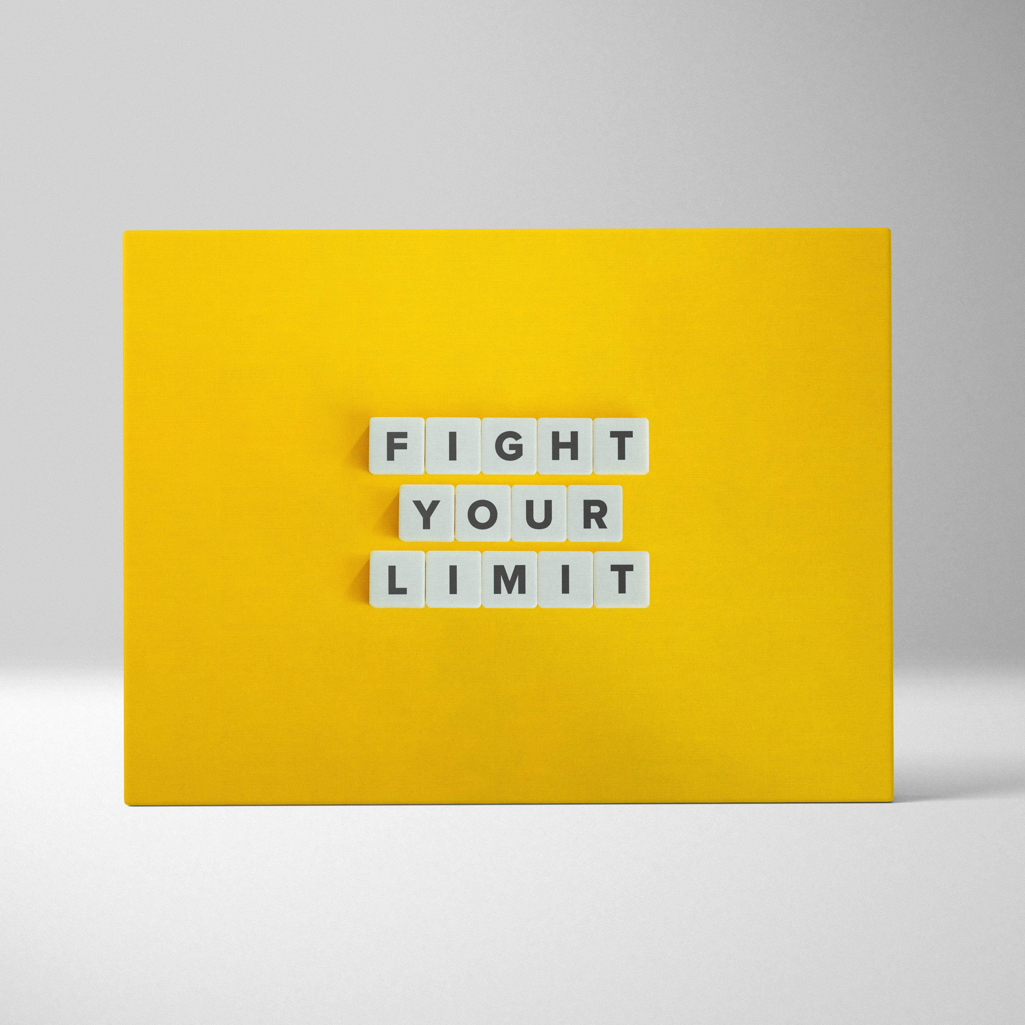 Bright yellow motivational wall art print with white letter tiles spelling fight your limit for gym or home decor