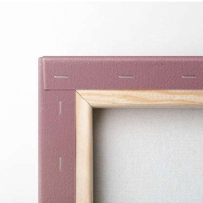 A mauve canvas frame with a light wood border and stitching featuring contemporary light bulb people wall art