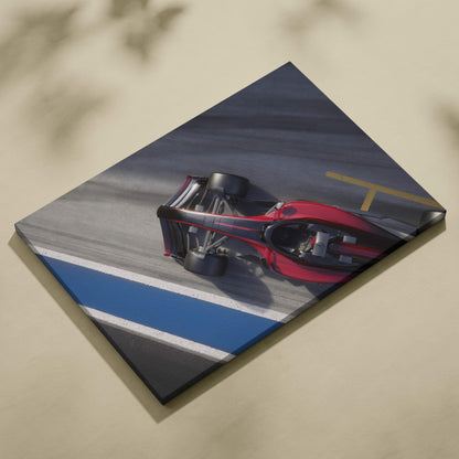 Red and black formula 1 race car printed on stretched canvas in overhead motorsport track photography style wall art