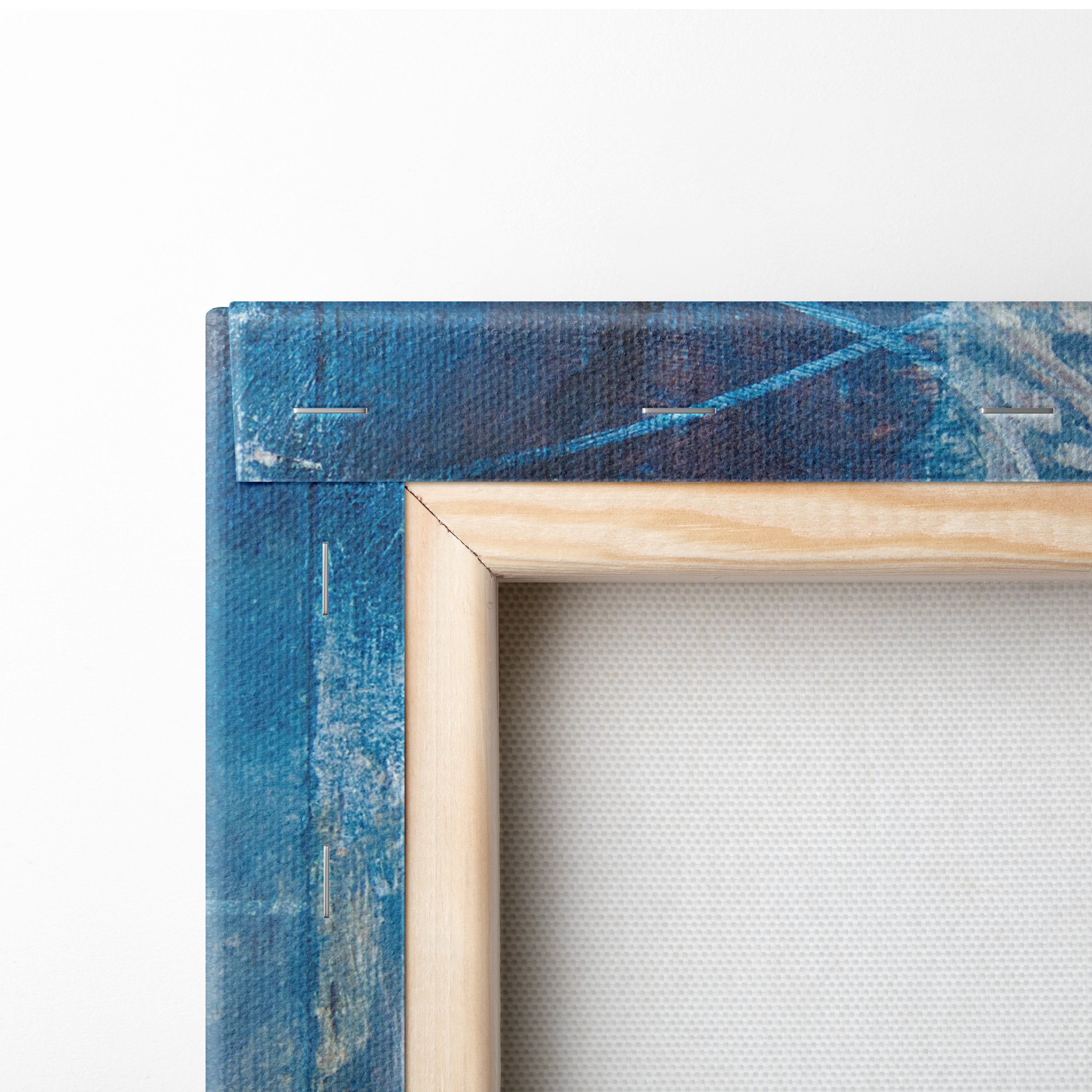 Light-colored wooden frame holding blue abstract graffiti canvas wall art print for eclectic living room decor