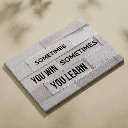 White wooden plaque with black engraved motivational growth mindset quote sometimes you win sometimes you learn for home decor