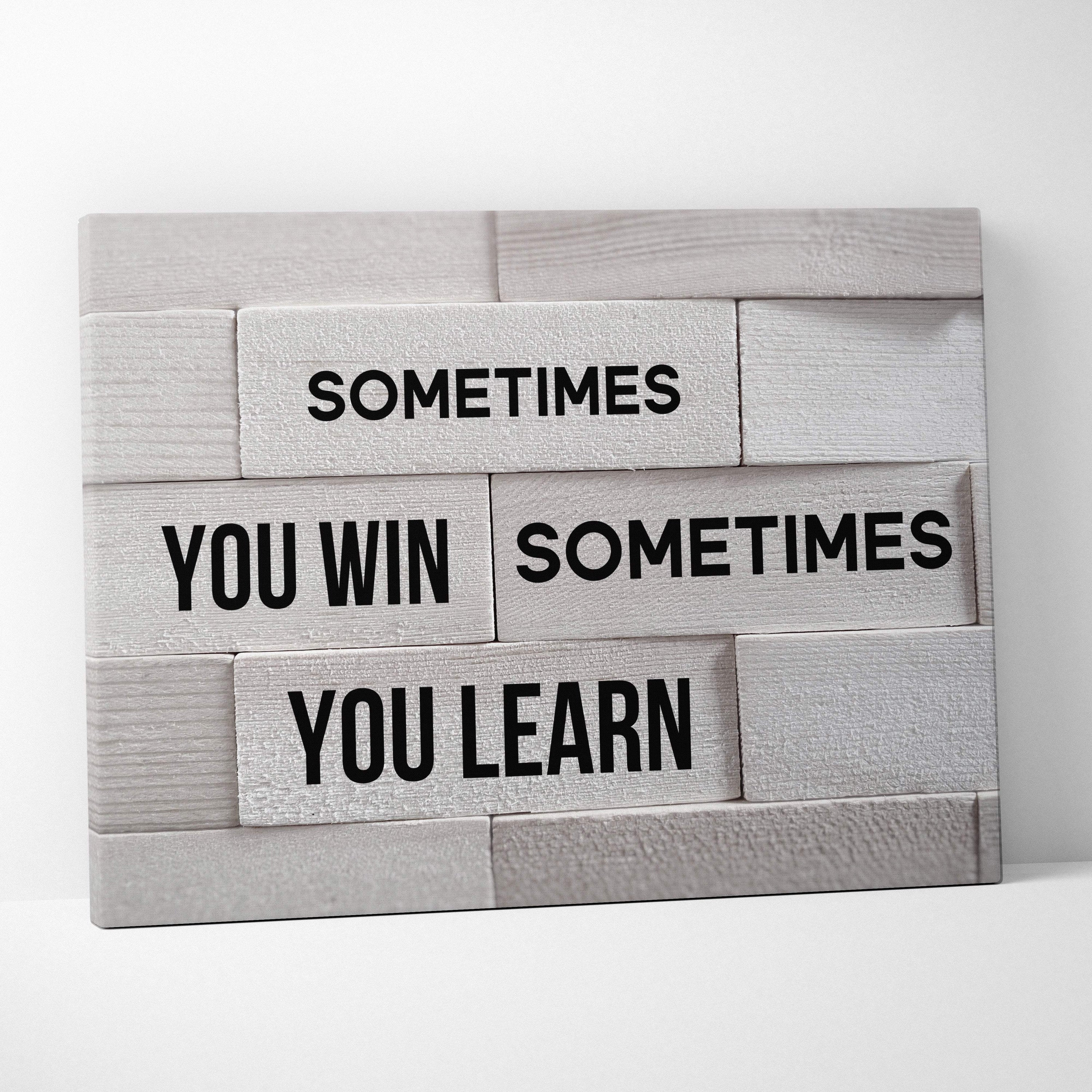 Gray wooden plank wall art with black text sometimes you win sometimes you learn motivational quote for home or office decor