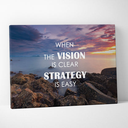 When the vision is clear strategy is easy motivational canvas print with serene sunset over rocky shoreline for office decor