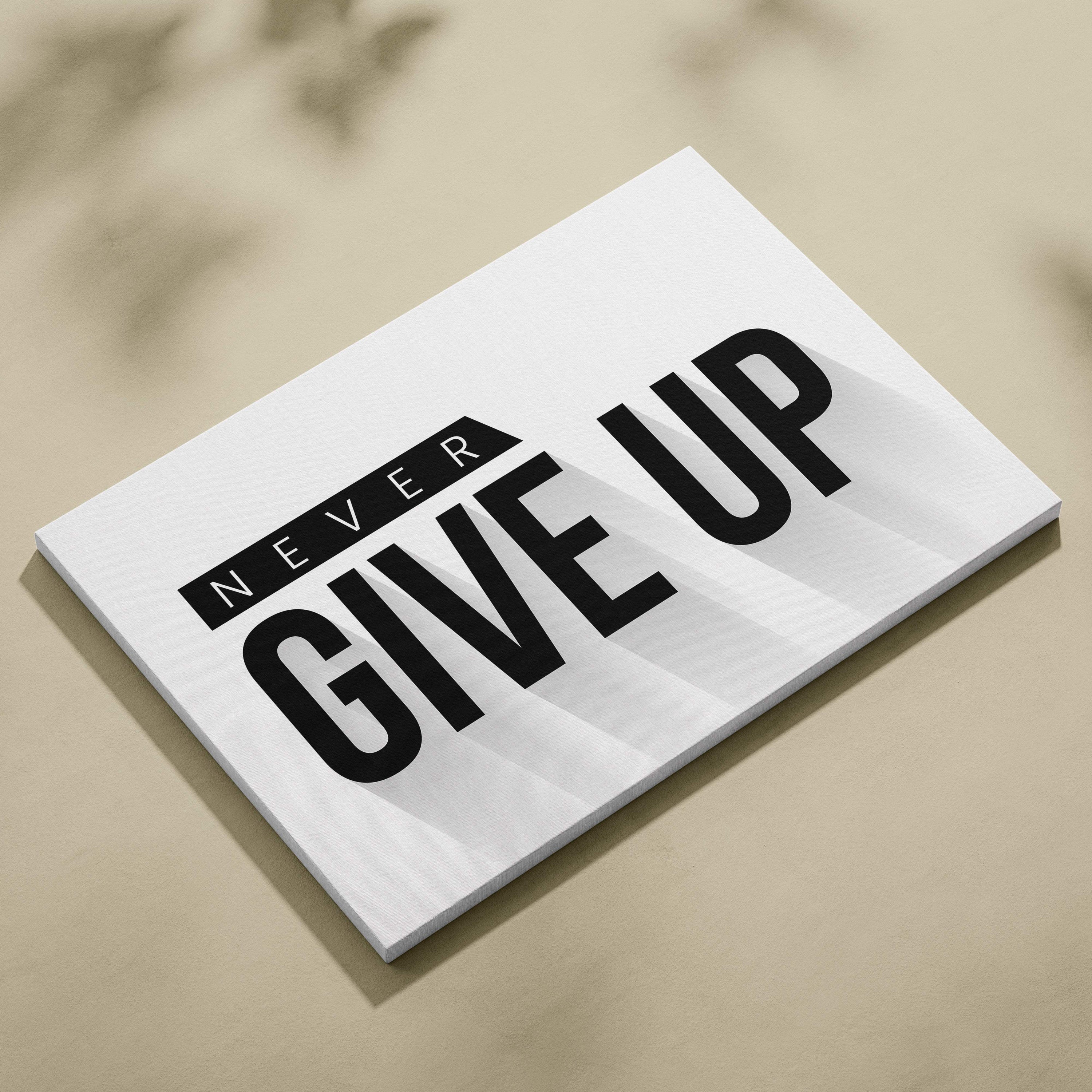 White rectangular canvas wall art print with bold black never give up text in modern font for office gym or home decor