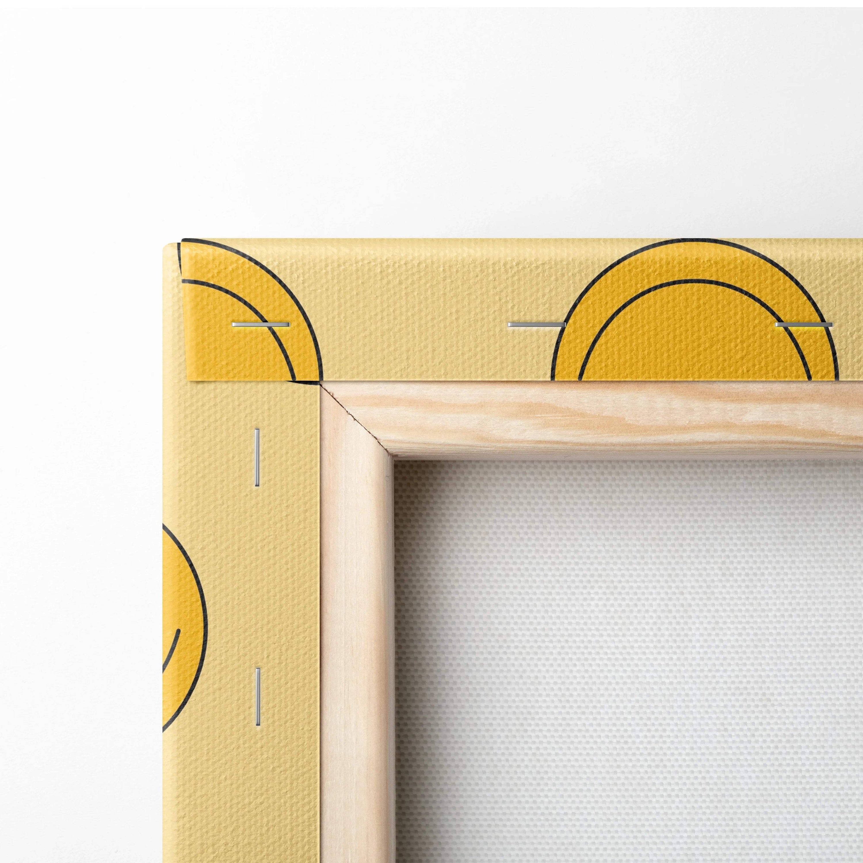 Cheerful yellow smiley emoji pattern canvas wall art with sun motifs in light wood frame