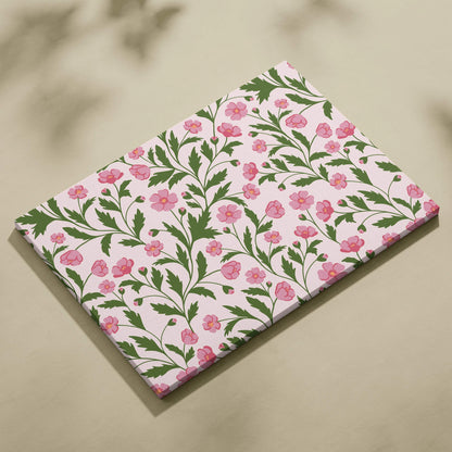 Seamless pink floral pattern canvas wall art with green leafy vines on soft blush background