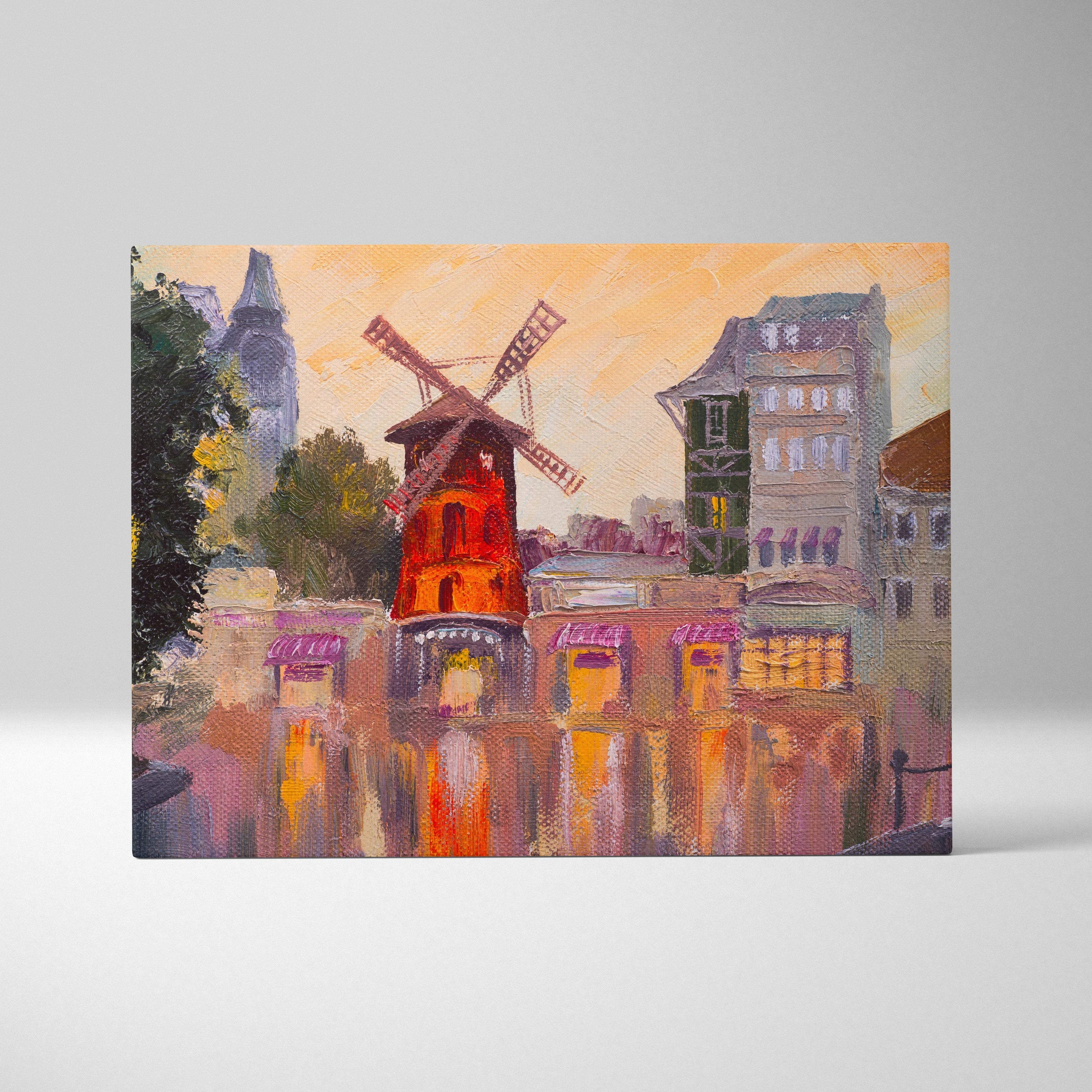 Paris windmill canvas wall art print featuring a red windmill with wooden blades by water and european buildings