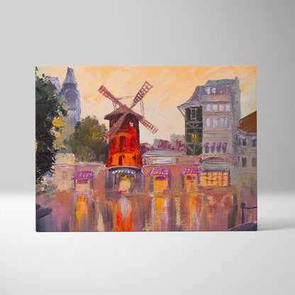 Paris windmill canvas wall art print featuring a red windmill with wooden blades by water and european buildings