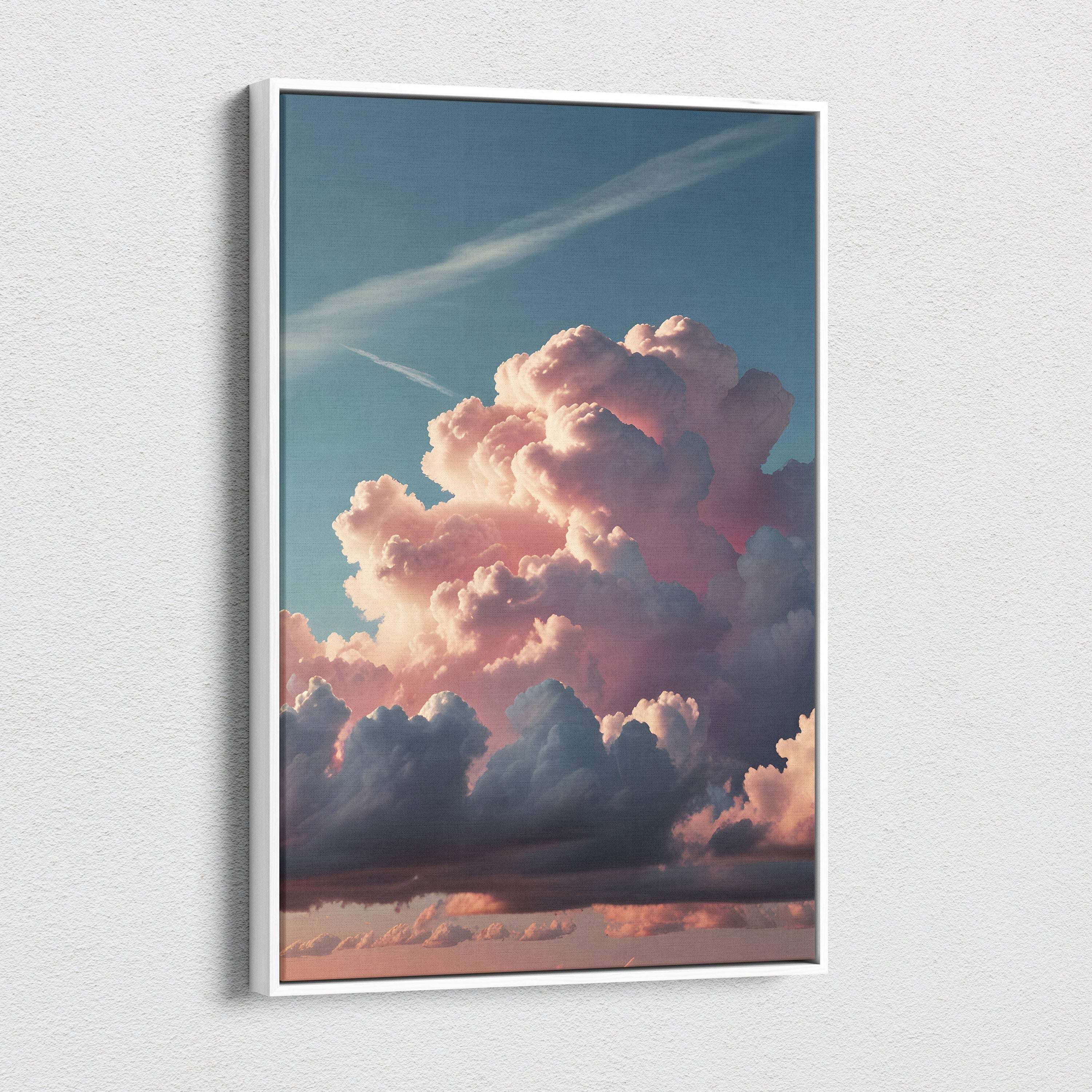 A framed canvas print of towering pink cumulonimbus clouds at sunset with soft pastel sky and dramatic cloudscape