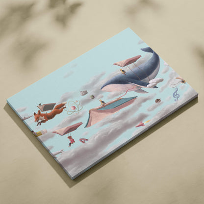 Contemporary canvas wall art featuring a blue whale with pink underbelly and flying open books surrounded by foxes and clouds