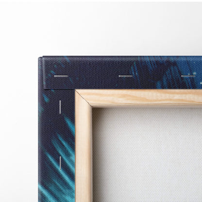 A framed canvas print with a dark blue and teal abstract design bordered by light wood for tropical night ocean decor