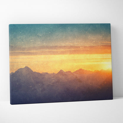 A rectangular canvas print of a golden mountain sunset with teal and orange hues for rustic living room decor