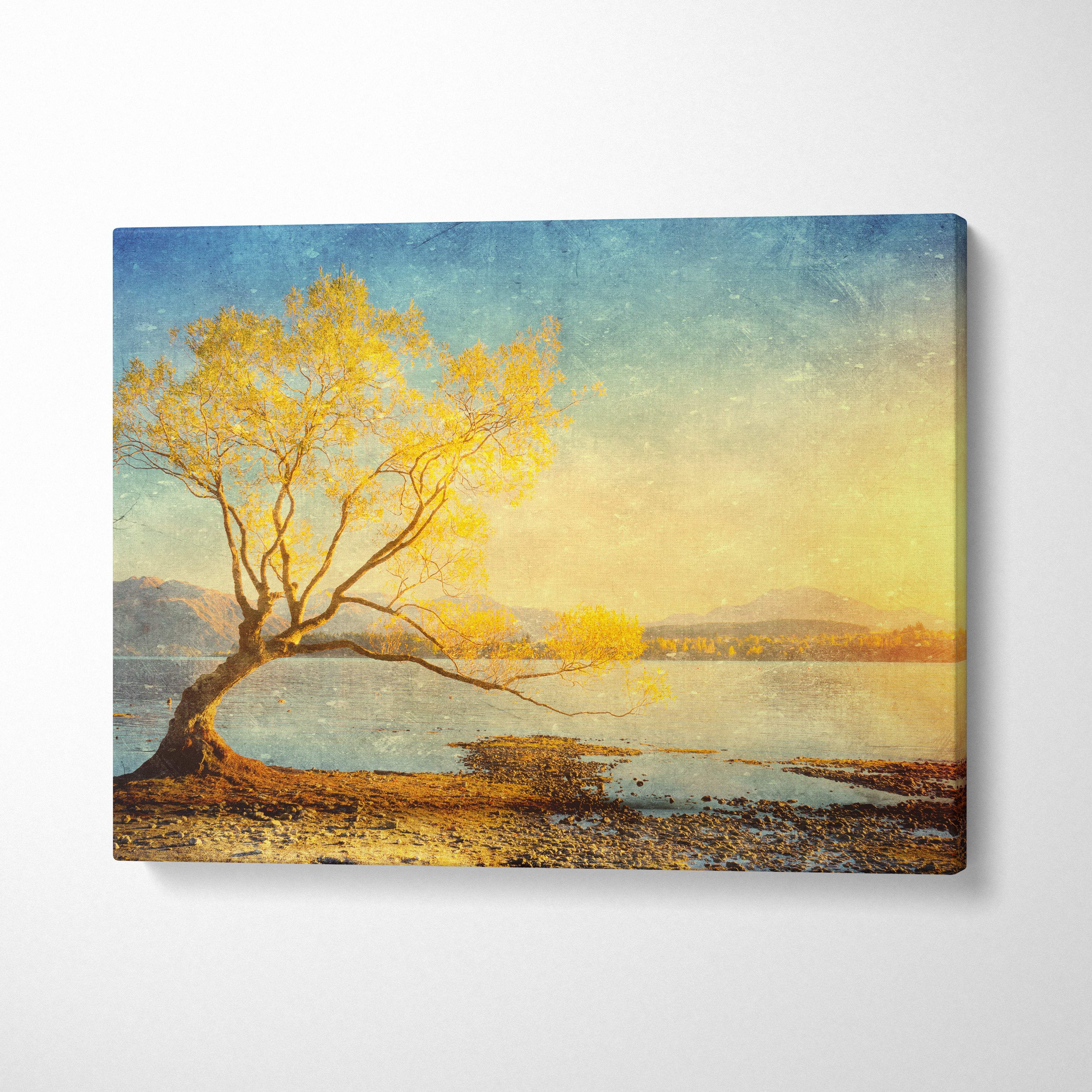Golden lake tree sunset canvas wall art print featuring a solitary golden tree leaning over calm waters under a soft sky