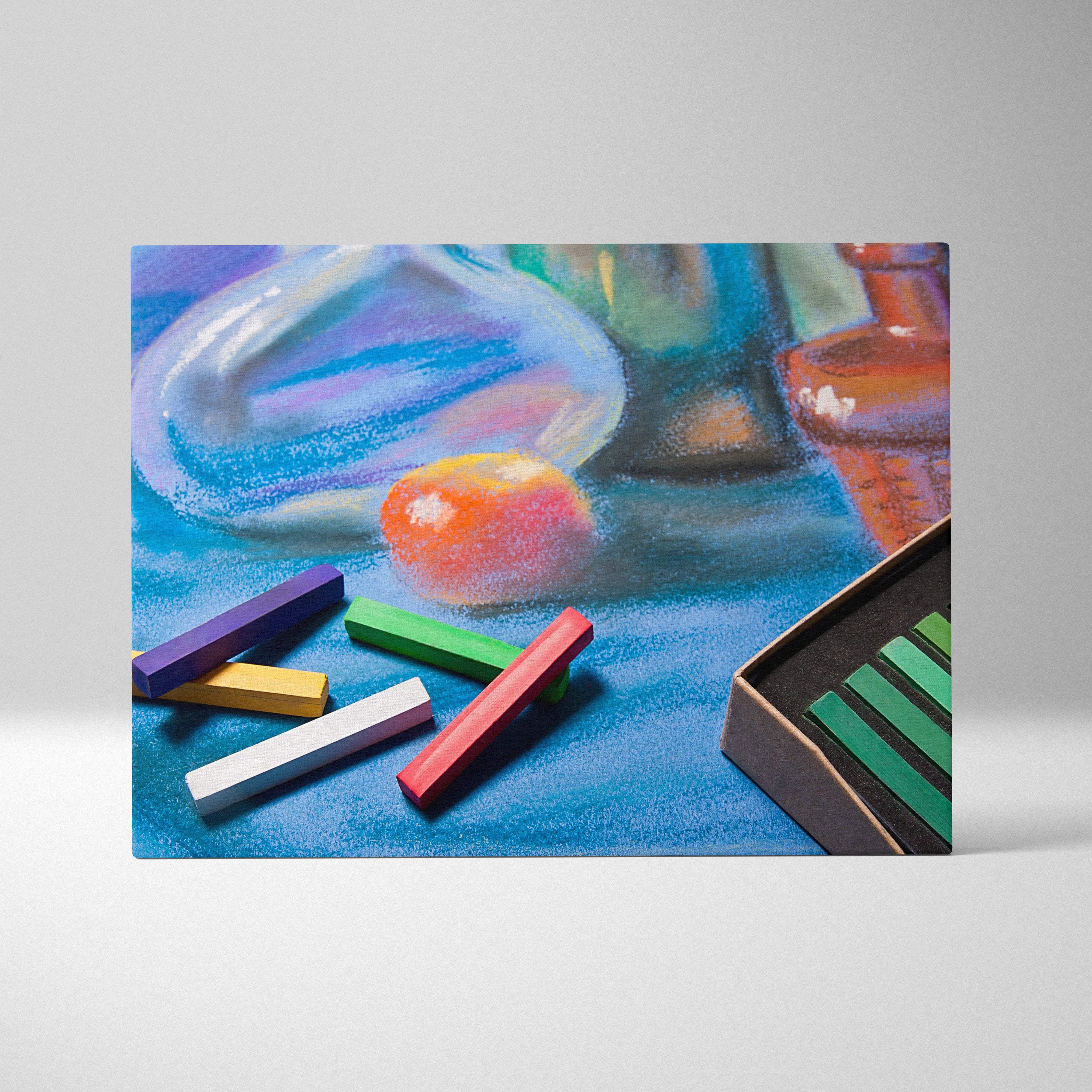 A vibrant pastel art supplies canvas print featuring colorful chalks and glassware on a textured blue surface