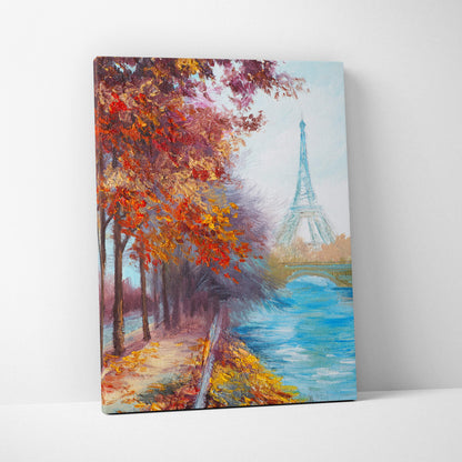 A vibrant paris autumn landscape canvas print featuring the eiffel tower framed by fiery red and gold trees along a riverbank