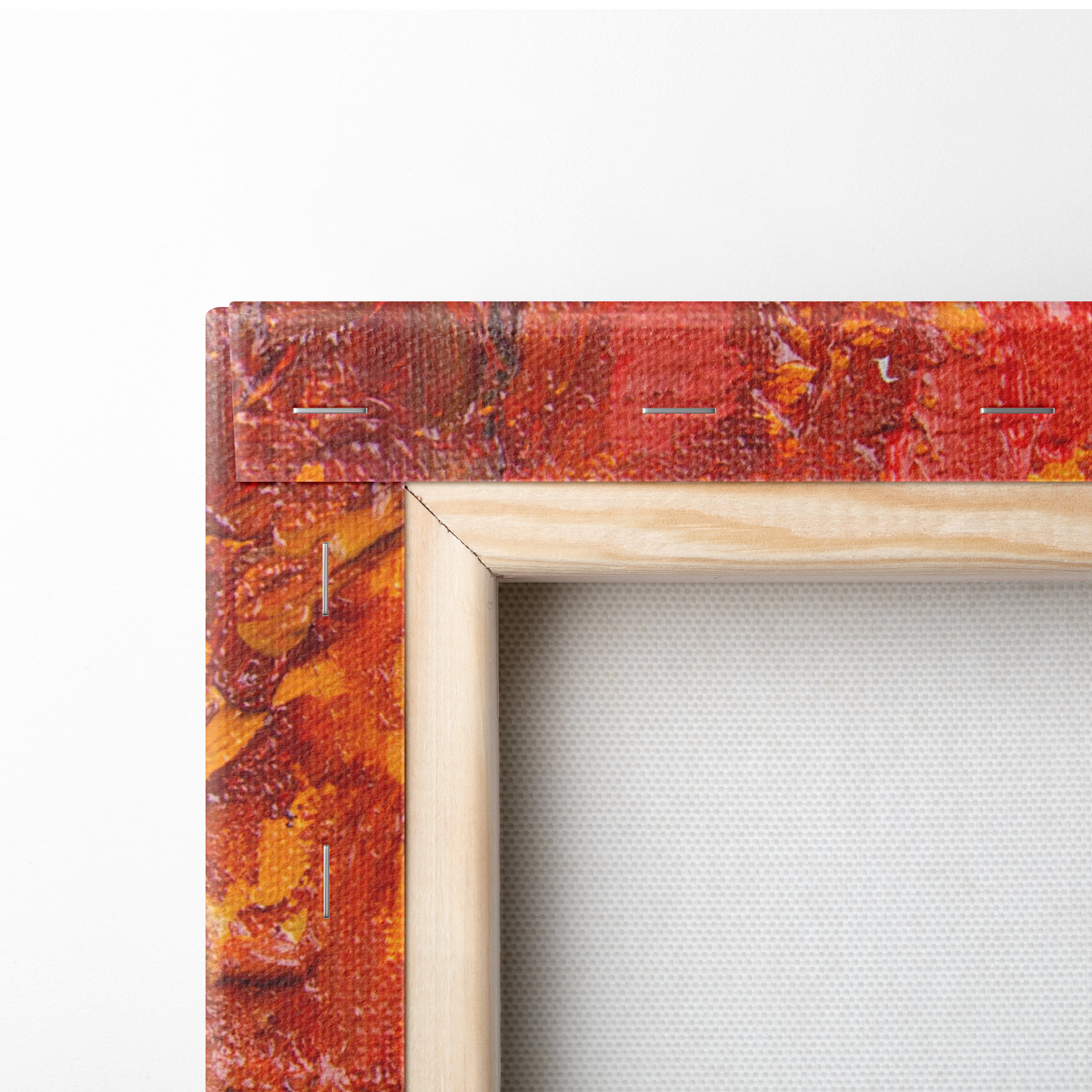 A vibrant abstract fiery red and orange textured canvas wall art print with stitched edges for rustic living rooms