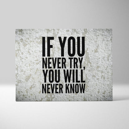 A rectangular canvas print with bold black motivational typography on textured gray concrete for office decor