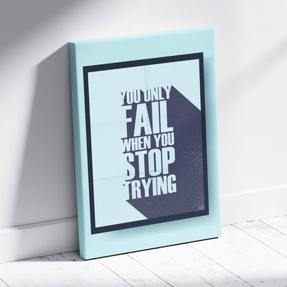 A light blue canvas print with bold white motivational quote you only fail when you stop trying on gray background for decor