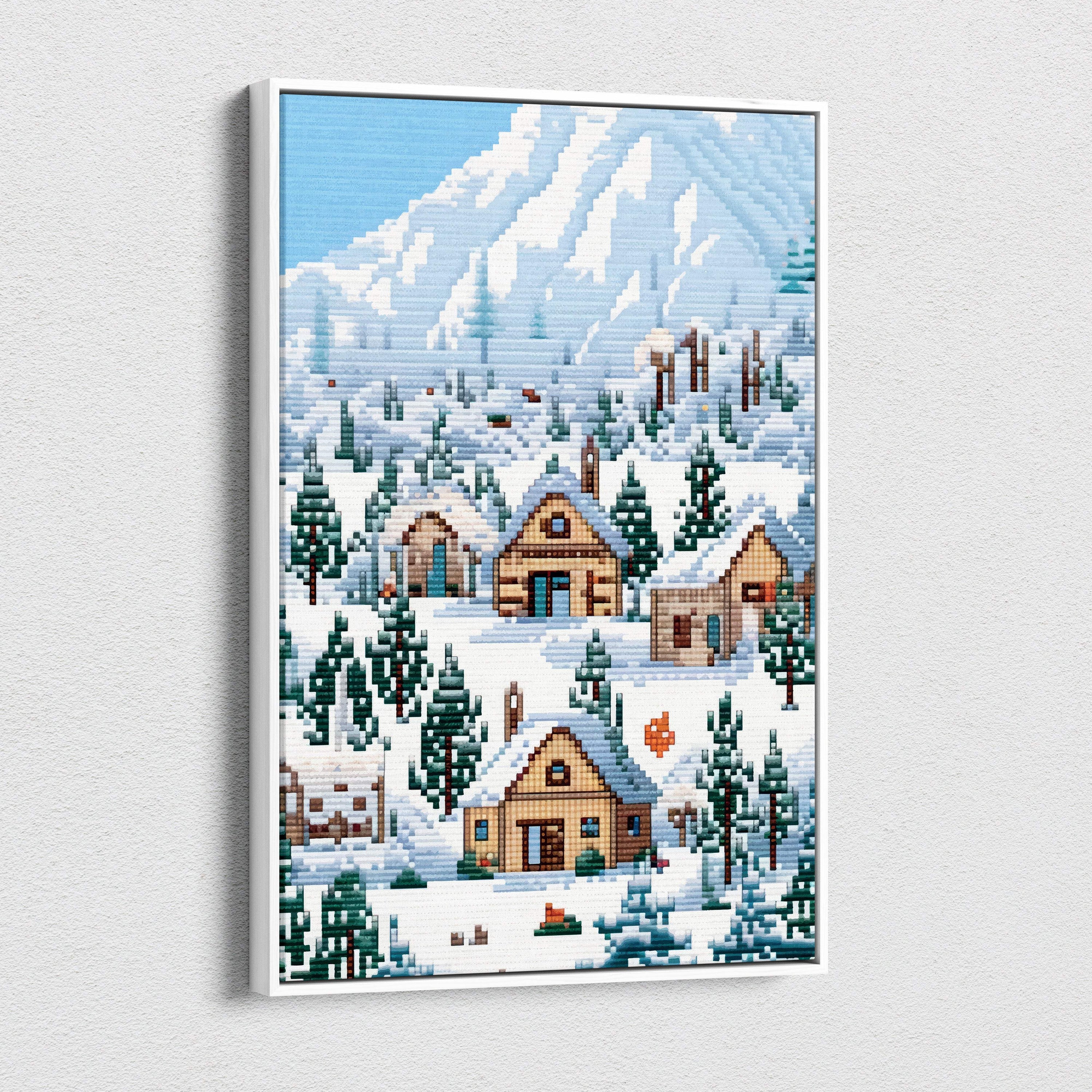A framed pixel art canvas print of a snowy mountain village with wooden cabins and evergreen trees in blue tones