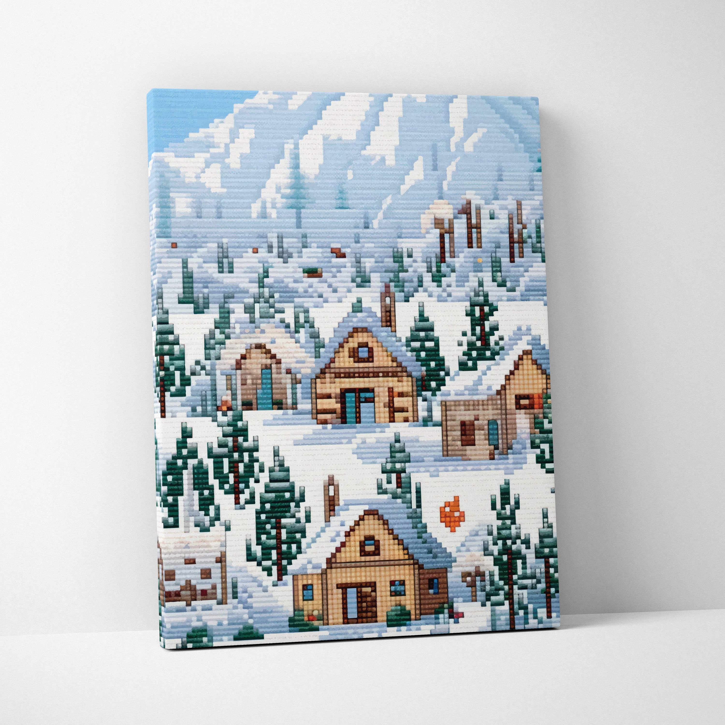 Snowy village pixel art canvas print showing snow-covered wooden houses and evergreen trees with blue mountain backdrop