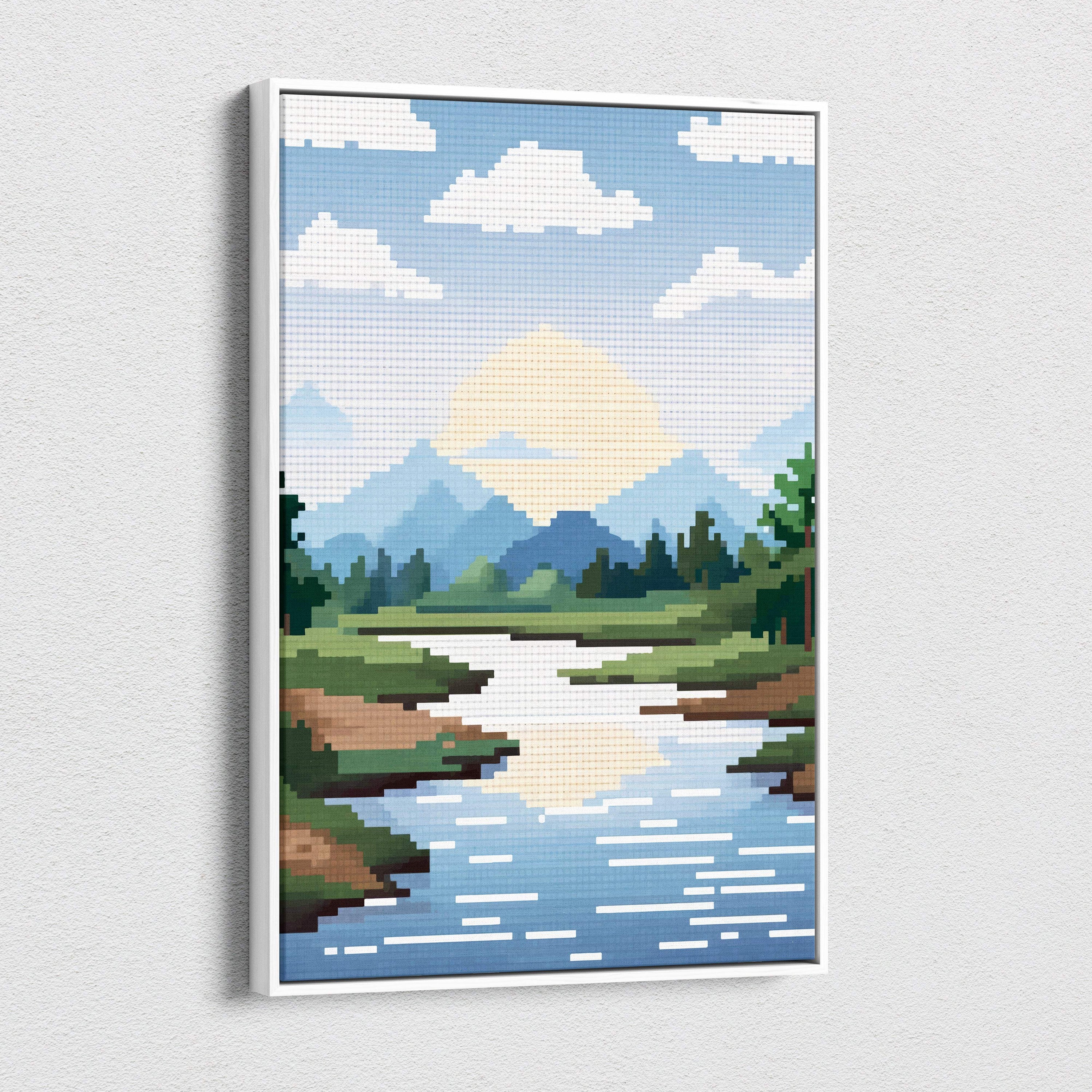 A framed pixel art canvas print of a blue green mountain valley with a winding river in a white frame for cabin decor