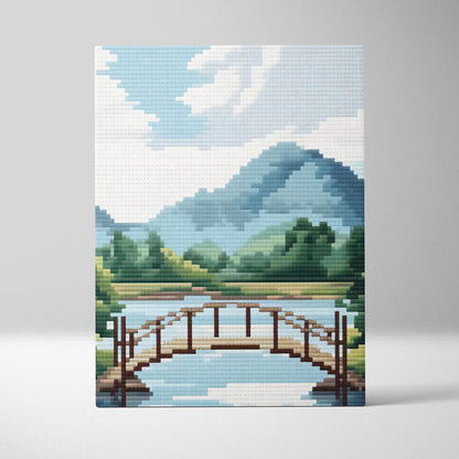 Mountain lake bridge pixel art canvas print showing a wooden arched bridge over blue water with green hills and mountains