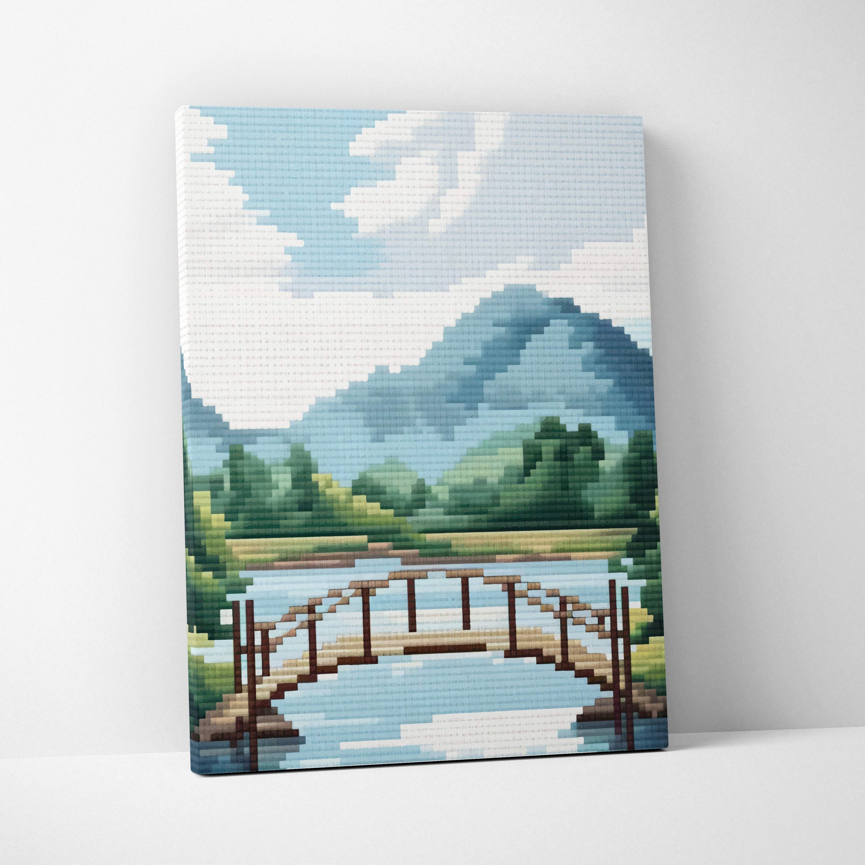 Mountain lake bridge pixel art canvas print with wooden bridge over blue green mountains and trees for peaceful cabin decor