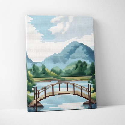 Mountain lake bridge pixel art canvas print with wooden bridge over blue green mountains and trees for peaceful cabin decor