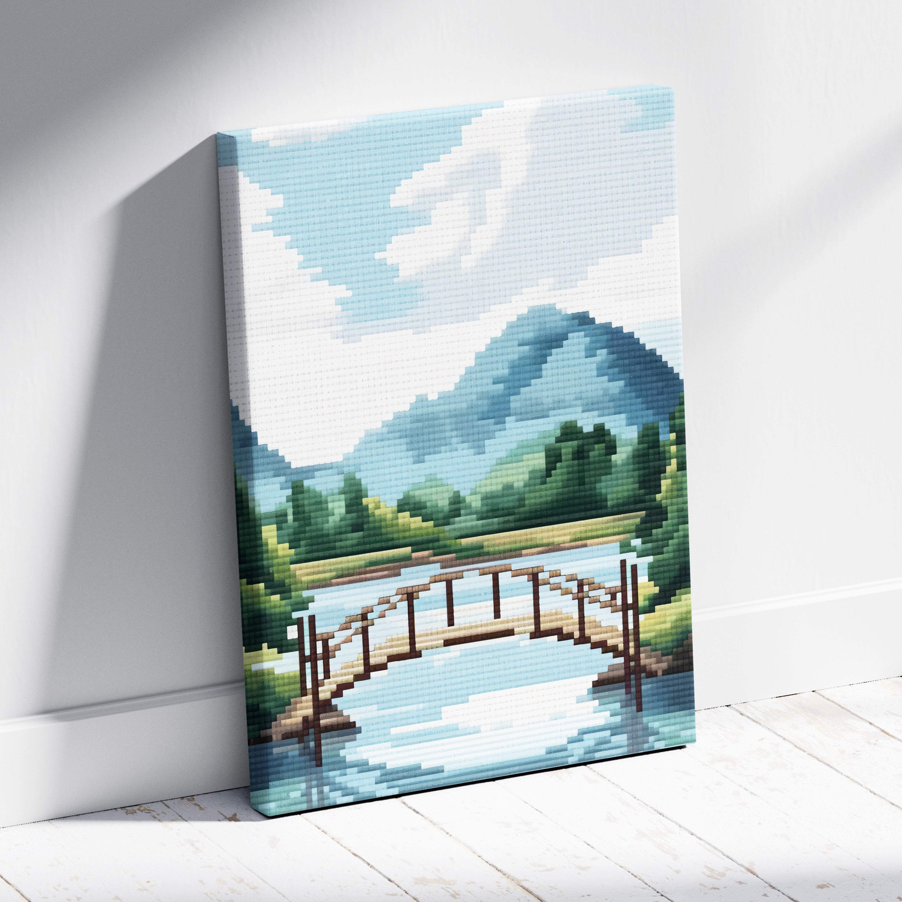 Mountain lake bridge pixel art canvas print showing a wooden bridge over a blue river with green hills and mountains